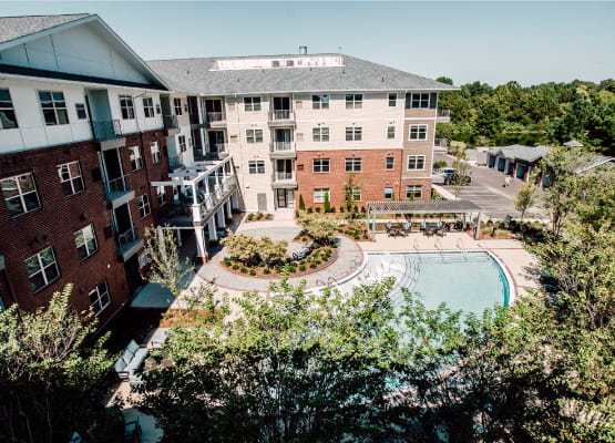 aerial view of pool with trees in foreground at avenida watermarq germantown