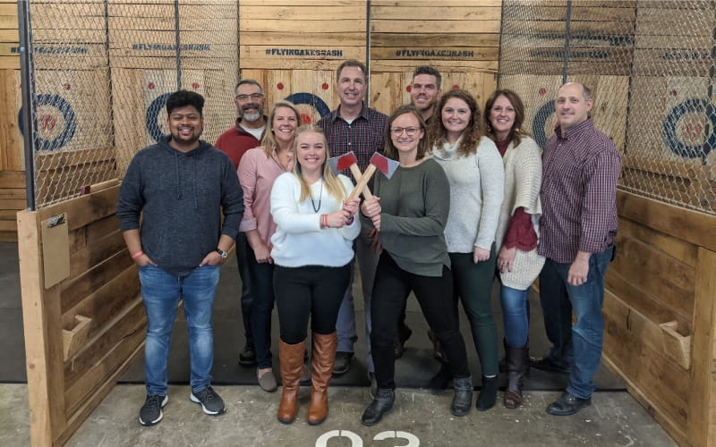 Kiser + Vogrin employees at axe throwing range