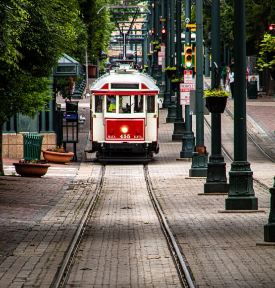 red and white train going down tracks