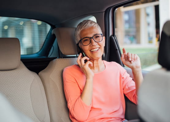 woman on cell phone in back of a car