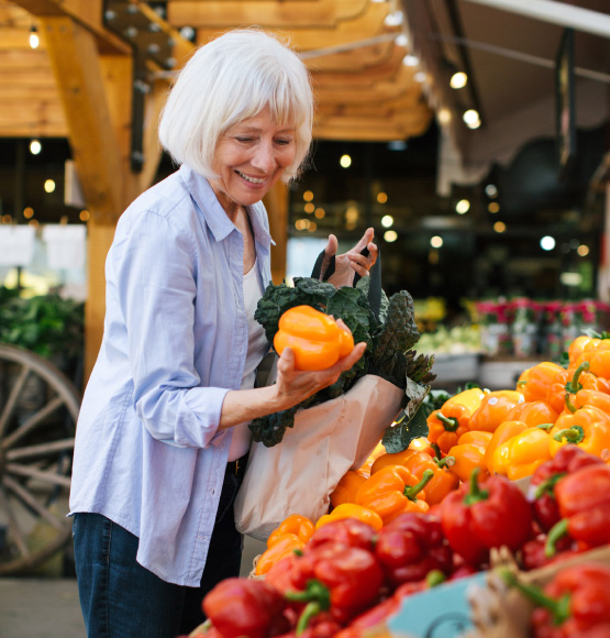 woman shopping for bell peppers