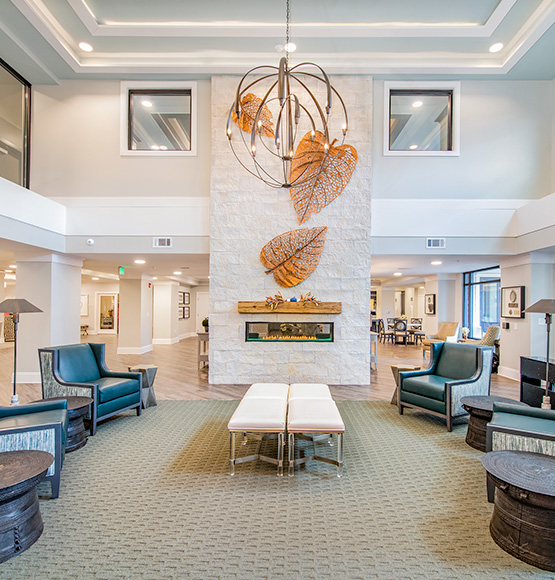 Resident lounge at our senior living community in Germantown, TN, featuring cushioned chairs, tables, and elegant decor.